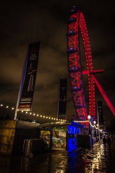 The London Eye illuminated at night in red