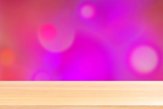 wood table board empty in front, wooden plank blank on bokeh pink purple luxurious background, perspective brown wood table front for mock up display products