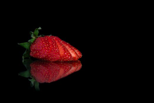 sliced strawberry with a place for text and a black background