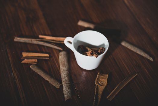 Top view of cinnamon on a white cup on a wooden background