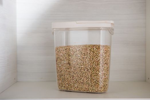 buckwheat in a transparent container for storing bulk products