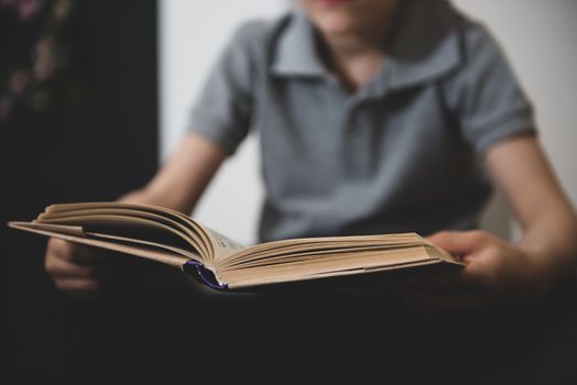 Blur image of a boy reading a book