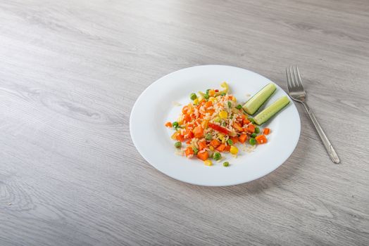 Hawaiian vegetable mix on white plate and light wooden table