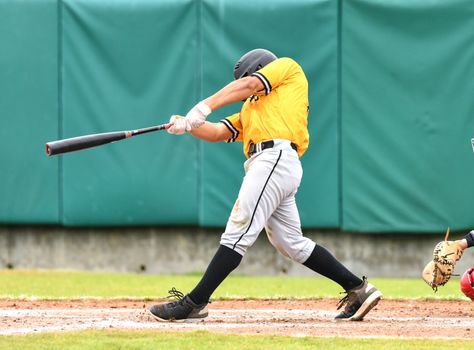 Action photo of high school baseball players making amazing plays during a baseball game