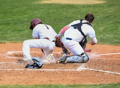 Action photo of high school baseball players making amazing plays during a baseball game