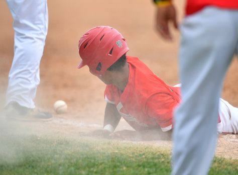 Action photo of high school baseball players making amazing plays during a baseball game