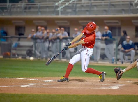 Action photo of high school baseball players making amazing plays during a baseball game