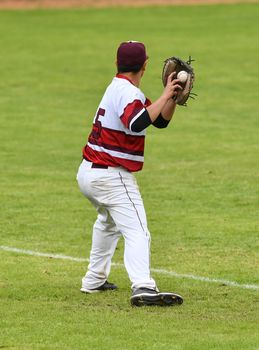 Action photo of high school baseball players making amazing plays during a baseball game