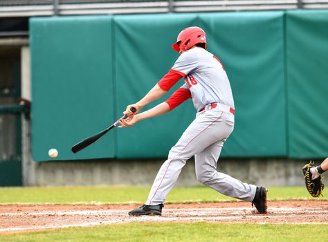 Action photo of high school baseball players making amazing plays during a baseball game