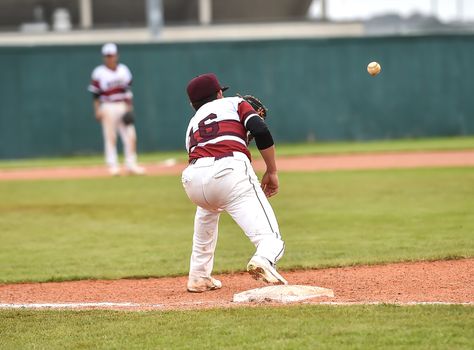 Action photo of high school baseball players making amazing plays during a baseball game