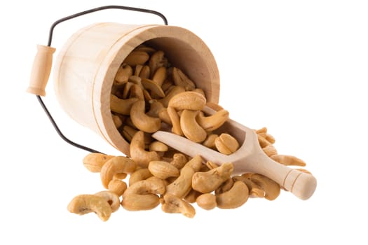 Closeup of cashew nuts in a Wooden buckets isolated on white background.