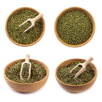 Raw mung bean or green bean in a wooden bowl isolated on white background.