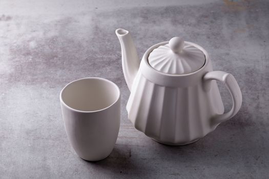 Teapot creamer, Cup and saucer on Cement Board.