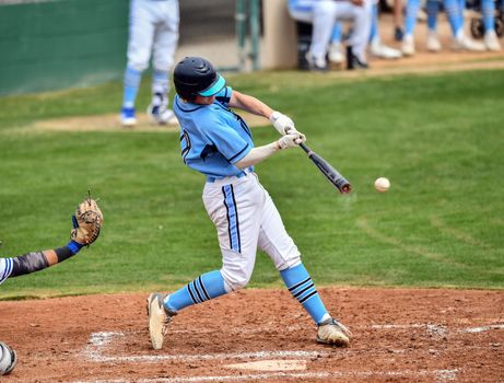 Action photo of high school baseball players making amazing plays during a baseball game