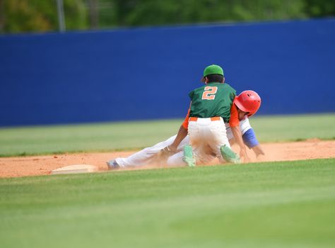 Action photo of high school baseball players making amazing plays during a baseball game