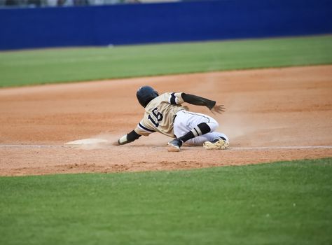 Action photo of high school baseball players making amazing plays during a baseball game