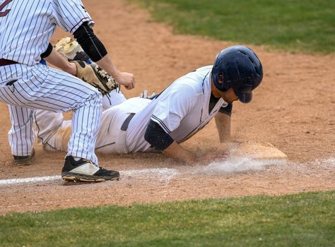 Action photo of high school baseball players making amazing plays during a baseball game