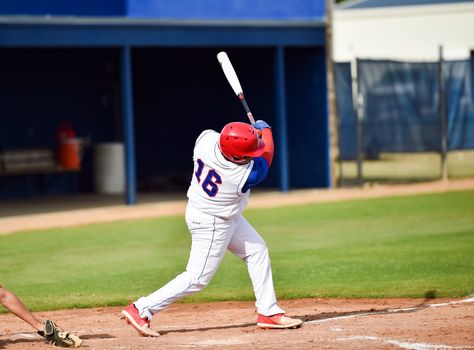 Action photo of high school baseball players making amazing plays during a baseball game