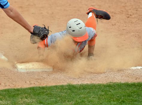 Action photo of high school baseball players making amazing plays during a baseball game