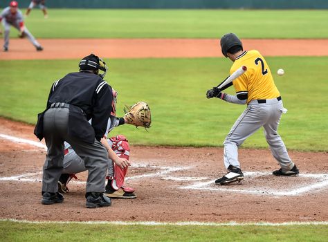 Action photo of high school baseball players making amazing plays during a baseball game