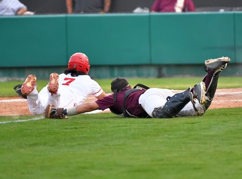 Action photo of high school baseball players making amazing plays during a baseball game