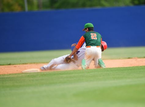 Action photo of high school baseball players making amazing plays during a baseball game