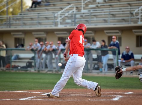 Action photo of high school baseball players making amazing plays during a baseball game