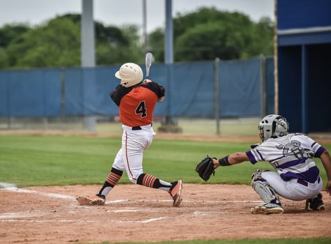 Action photo of high school baseball players making amazing plays during a baseball game