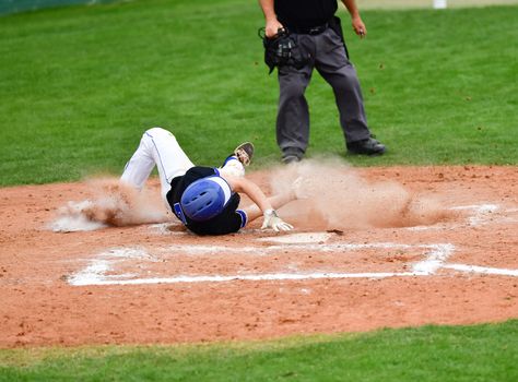 Action photo of high school baseball players making amazing plays during a baseball game