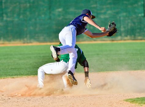 Action photo of high school baseball players making amazing plays during a baseball game