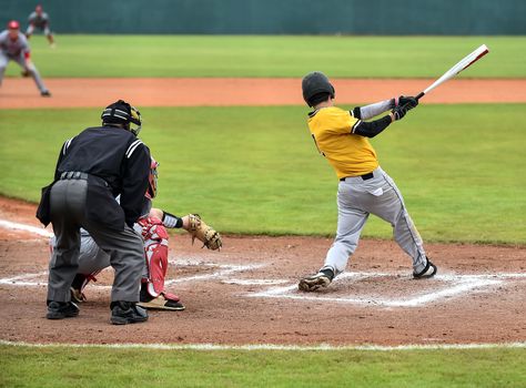 Action photo of high school baseball players making amazing plays during a baseball game