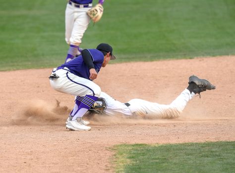 Action photo of high school baseball players making amazing plays during a baseball game