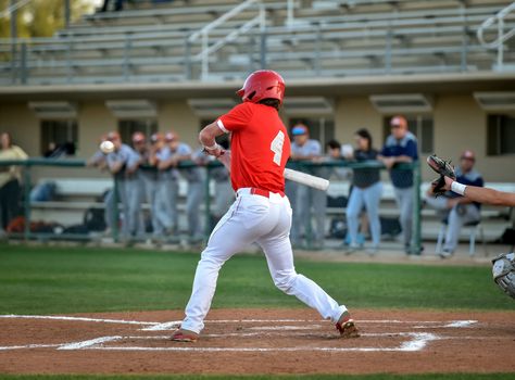 Action photo of high school baseball players making amazing plays during a baseball game