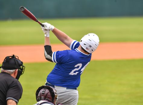 Action photo of high school baseball players making amazing plays during a baseball game