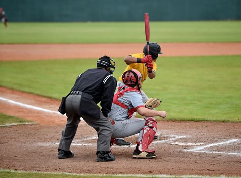 Action photo of high school baseball players making amazing plays during a baseball game