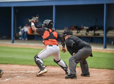 Action photo of high school baseball players making amazing plays during a baseball game