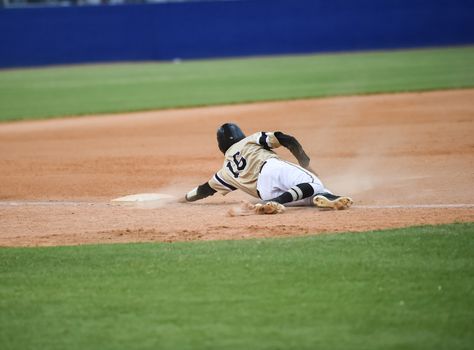 Action photo of high school baseball players making amazing plays during a baseball game