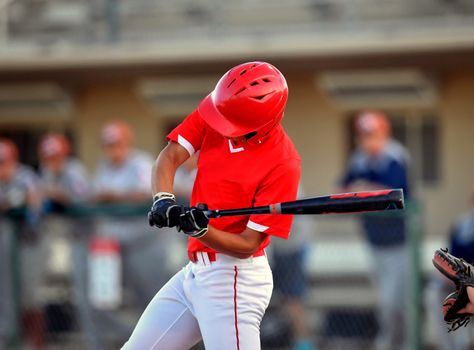 Action photo of high school baseball players making amazing plays during a baseball game