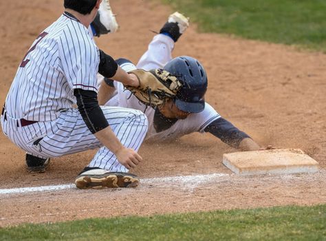 Action photo of high school baseball players making amazing plays during a baseball game