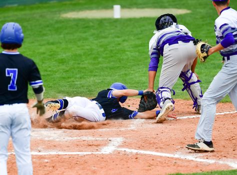 Action photo of high school baseball players making amazing plays during a baseball game