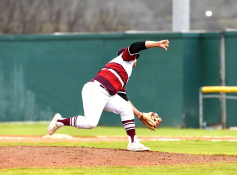 Action photo of high school baseball players making amazing plays during a baseball game