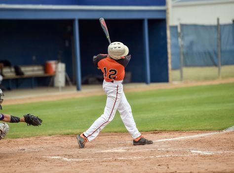 Action photo of high school baseball players making amazing plays during a baseball game