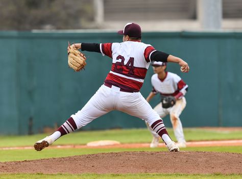 Action photo of high school baseball players making amazing plays during a baseball game