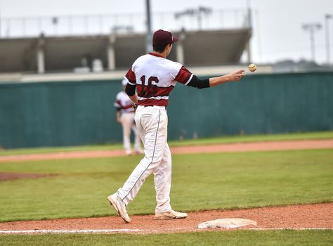 Action photo of high school baseball players making amazing plays during a baseball game