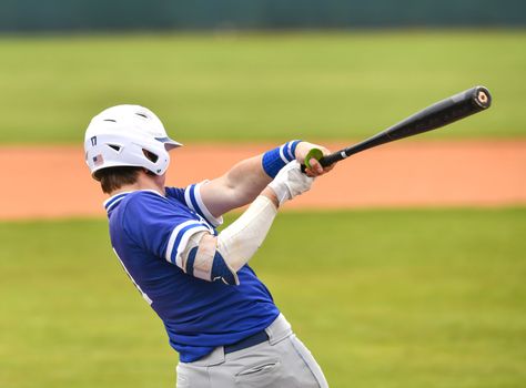 Action photo of high school baseball players making amazing plays during a baseball game