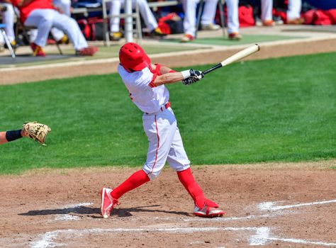 Action photo of high school baseball players making amazing plays during a baseball game