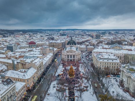 Lviv, Ukraine, December. Arial shot. Lvov Opera house. Christmas tree. Christmas Fair. People are walking around the city center
