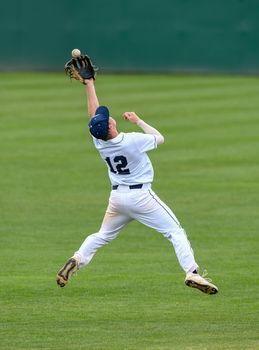 Action photo of high school baseball players making amazing plays during a baseball game