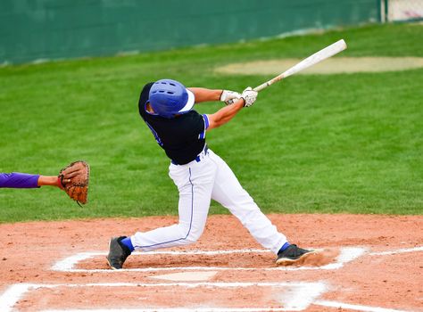 Action photo of high school baseball players making amazing plays during a baseball game