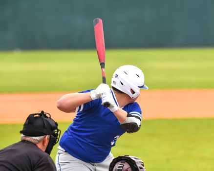 Action photo of high school baseball players making amazing plays during a baseball game